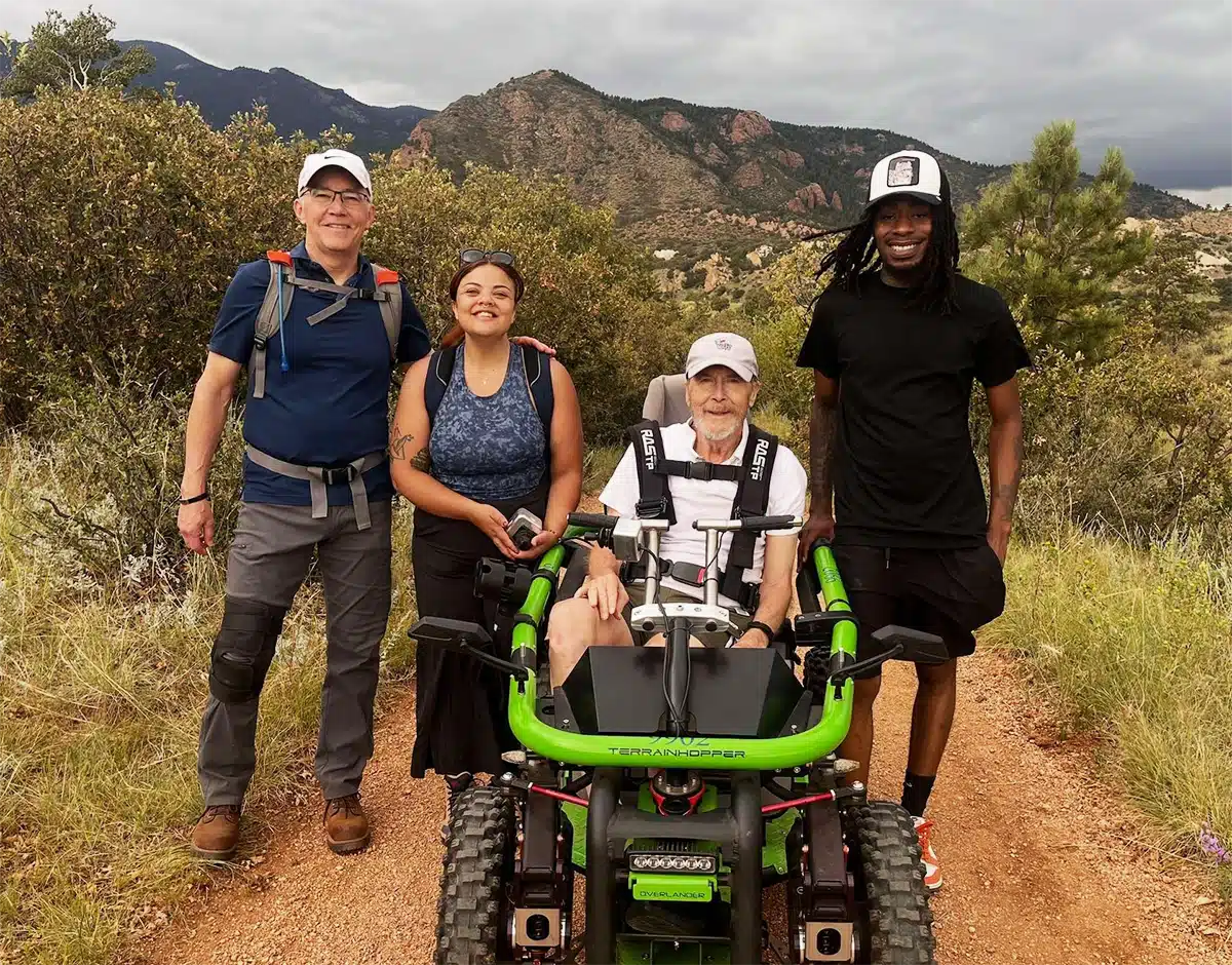MorningStar resident enjoys a Colorado nature trail with Glapion and other team members