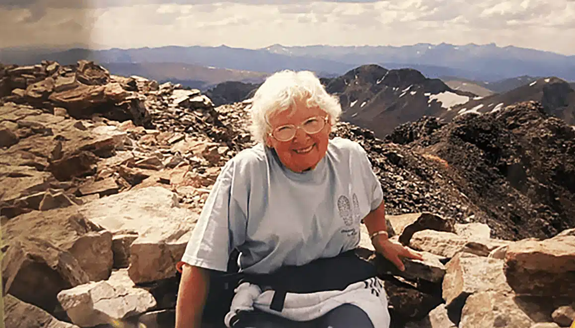 Woman on top of mountain